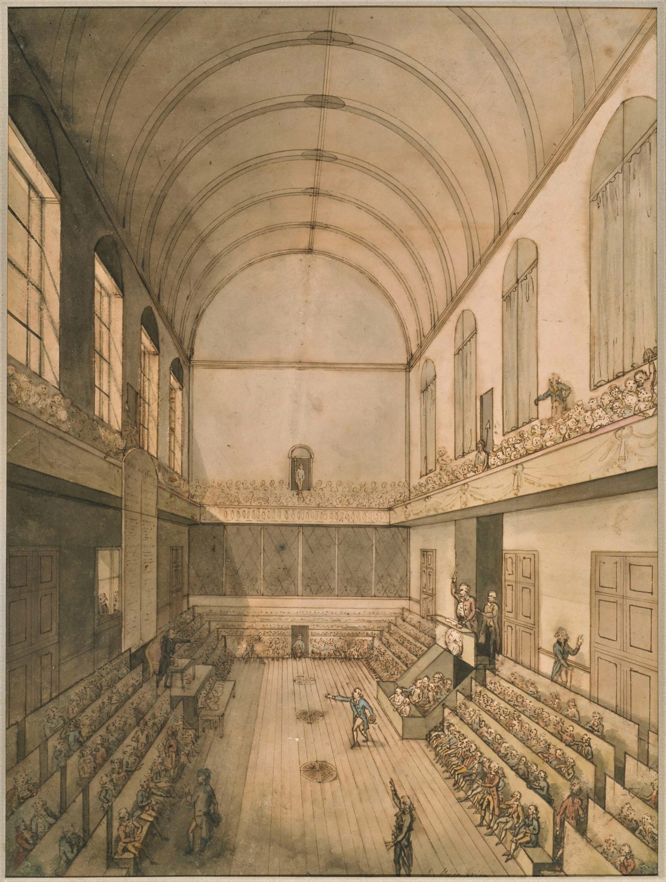 Grabado coloreado del interior de la Escuela de Equitación de las Tullerías convertida en sala de la Asamblea: una nave alargada con bóveda de cañón, ventanales a la izquierda, tribunas de público en los laterales y filas de bancos ocupados por diputados a ambos lados de un pasillo central.